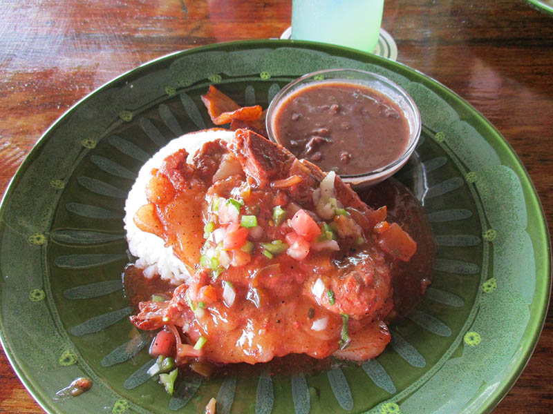 Special of the day at Waluco's Bar and grill. Sweet and sour pork chop with rice and stew beans. 