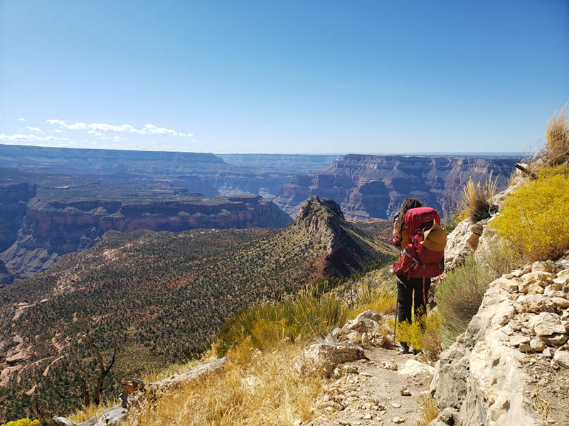 how to train for hiking | woman with large backpack looking over grand canyon