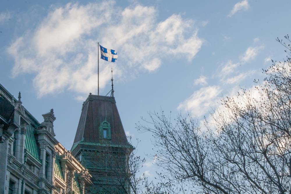 The flag of Quebec flying over its capital, Quebec City. 