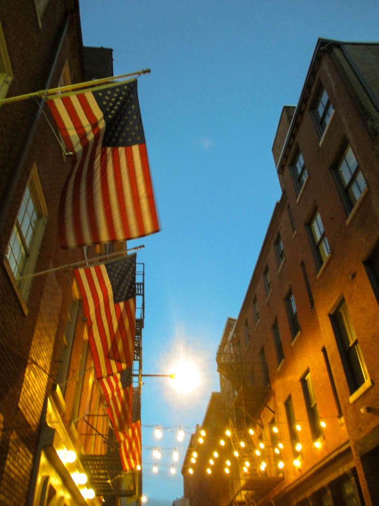 American flags and twinkly lights above the entrance to the hostel.