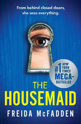 Blue book cover for The Housemaid featuring a close up brown eye staring through a keyhole in a painted blue door. White text at the top reads “From behind closed doors, she sees everything.” A silver badge says “#1 New York Times Mega-Bestseller,” with the title “The Housemaid” in large yellow letters and “Freida McFadden” in white at the bottom.